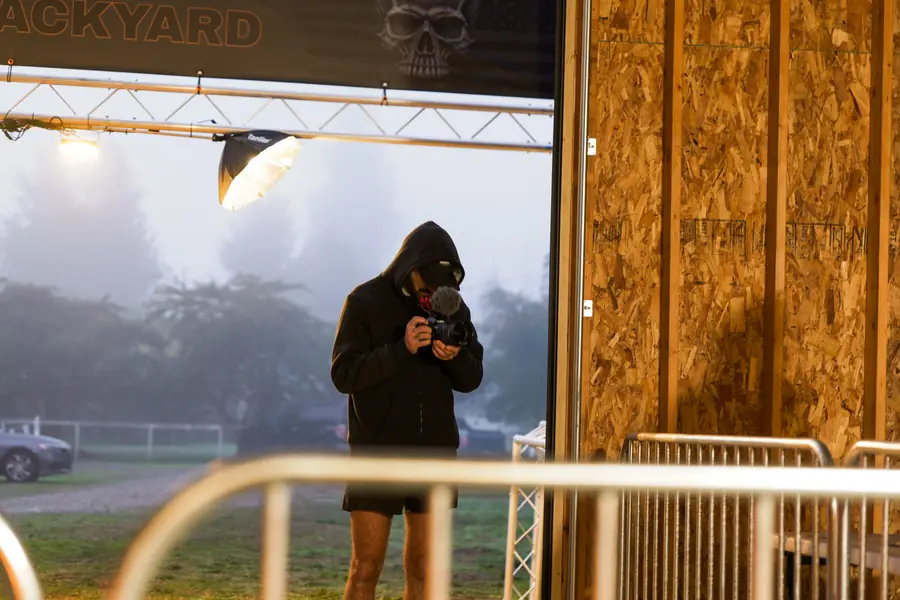 Race photographer shooting from the start corral on a foggy morning at a backyard ultra