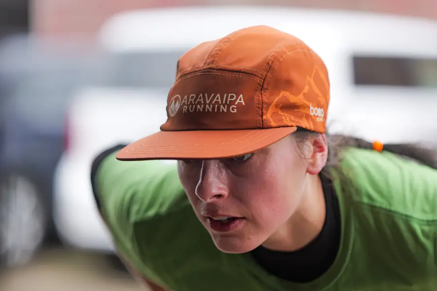 Close-up of an ultramarathon runner bent over and focused during a race